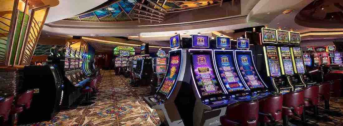 Many slot machines together in a room of a casino hotel
