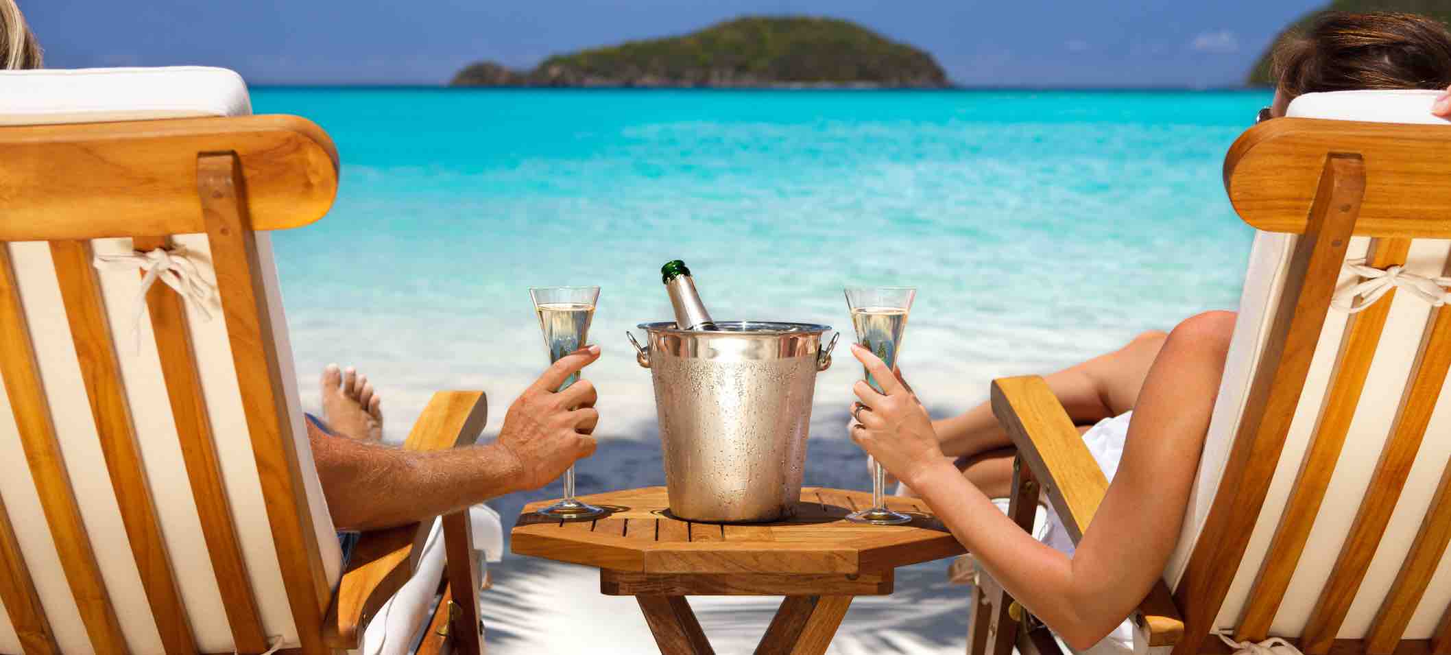 A couple having a glass of champagne in front of the beach