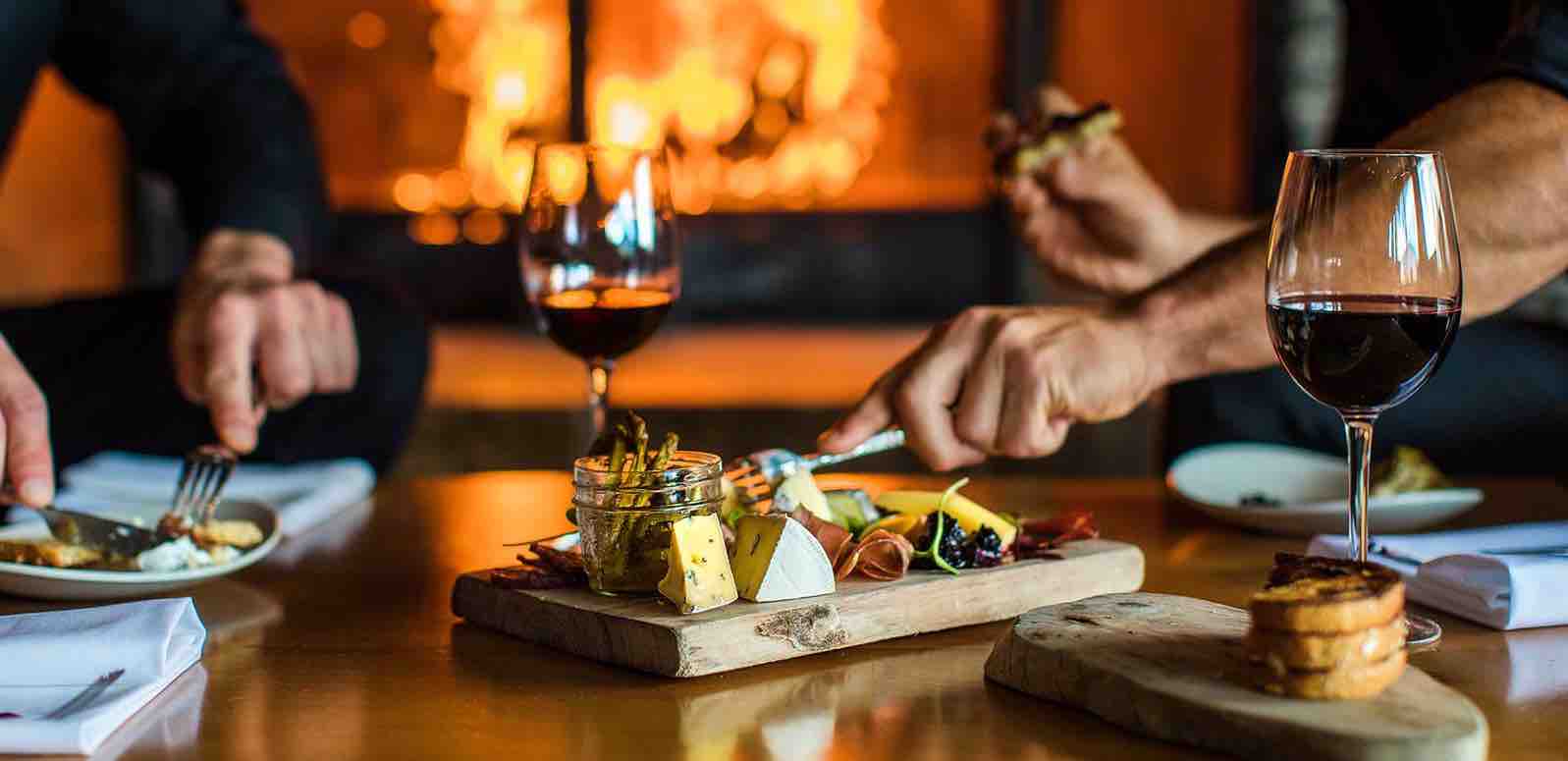 A couple enjoying dinner with a glass of wine